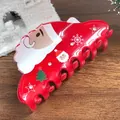 Détail d'une pince à cheveux Père Noël rouge avec strass et motifs festifs - Père Noël