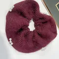 Elegant wine red knitted scrunchie with white pearl accents on textured surface - Pearl Wine Red