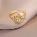 Elegant gold flower ring with rotating zircon petals on champagne silk background - Gold Multi-layer Petal Zirconia Style (J0053)