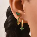 Detail of three-piece gold-plated earrings set with green cubic zirconia on model ear - Green Style (AEH70352)