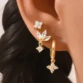 Close-up of three gold geometric stud earrings with zircons on a female model ear - Light Gold Clear Style (AEH70352-6)