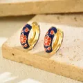 Detailed view of navy blue enamel hoop earrings with red floral patterns on a stone base - Hoop Huggie (1 Pair) / Gold Base Navy Enamel Red Floral (EH5456-4)