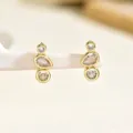 Macro detail of gold-plated earrings featuring three vertical clear crystals on a white stand - Triple Stone Arrangement Clear Zircon (EH5517)