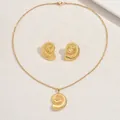 Macro detail of golden spiral shell jewelry set with necklace and matching stud earrings - Bionic Spiral Texture Style (XL5735)