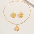 Close-up of golden geometric jewelry set featuring woven textures on oval pendants - 3D Woven Texture Oval Style (XL5736)