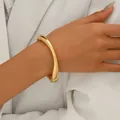 Minimalist 18k gold wave-shaped metal bangle with polished mirror finish for women - Gold Wave Style (SL7768)