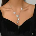 Detailed view of silver Y-shaped tassel necklace with polished heart charms on model - Silver Multi-Heart Y-Shaped Tassel Necklace (XL5590-2)