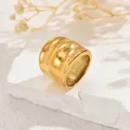 Primer plano de un anillo dorado pulido y grueso sobre una base de piedra natural - Estilo Ancho Doble Redondeado Dorado (JZ1294-7)