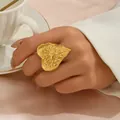 Statement gold heart ring with hammered texture and sunburst design on model's finger - Radiating Rays Heart Style (JZ1312-4)