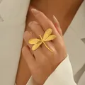 Golden dragonfly open ring with hammered texture wings on a female hand model - Dragonfly Wings Style (JZ1312-3) / Gold