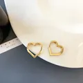 Minimalist heart-shaped gold hoop earrings made of polished alloy in a golden finish - Gold Small