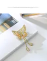 Elegant gold butterfly brooch with sparkling rhinestones and delicate tassels - Gold