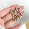 Orecchini a doppio anello dorati con zirconi scintillanti e finitura lucida elegante - Orecchini a Catena - Grandi