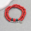 Detail of red beaded bracelet featuring an ethnic silver tube and floral pendant charm - Vibrant Red Double Wrap (SL7640-3)
