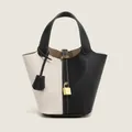 Contrast PU leather bucket bag in black and white with gold padlock and pebbled texture - Black and White Patchwork