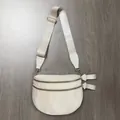 Close-up of beige nylon crossbody bag with double gold zippers and wide woven strap - Off White