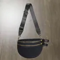 Close-up of black mesh crossbody bag featuring dual golden zippers and adjustable strap - Mesh Black
