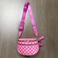 Close-up of pink checkered waist bag with dual zippers and adjustable nylon strap - Rose Red Checkerboard