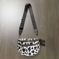 Crossbody bag with cow print pattern and adjustable black strap in shell shape - Black Cow