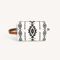 Detail of bohemian geometric pattern on waterproof PU leather travel toiletry bag - White