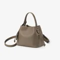 Versatile taupe litchi grain leather bucket bag with top handle and crossbody strap - Gray