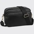 Detail of black leather crossbody bag with dual gold zippers and wide shoulder strap - Black