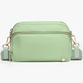 Detail view of mint green crossbody bag with golden hardware and nylon texture - Green
