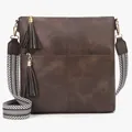 Close-up of vintage brown crossbody bag with pebble grain texture and jacquard strap - Coffee