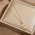 Bamboo-style opal pendant necklace in gold finish with delicate leaf details - Bamboo Necklace (L0150) / Gold
