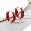 Minimalist oval earrings in gold-tone metal with deep red enamel gloss finish - Red Brown