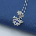 Silver shell locket necklace with dark blue gemstones on blue fabric background - Dark Blue