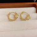 Golden zodiac dragon hoop earrings with woven texture and intricate head details - Gold