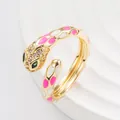 Punk style snake ring with pink and white enamel dots and green gem eyes in gold finish - Open Adjustable / Glitter
