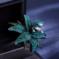 Elegant lily brooch with green rhinestones and crystals on black metal frame - Green