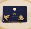 Elegant gold leaf-shaped stud earrings with cat eye stone on a branded card display - Leaf Style (D0613)