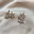 Luxury gold star ear cuff with sparkling cubic zirconia on champagne silk background - Gold Double Star Style (J0049)