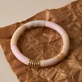 Detail of bohemian acrylic tube bracelet with pink and marble beads on brown paper - Pink and Cream Marble Pattern (AB0092-1)