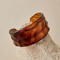Détail macro d'un bracelet manchette en acrylique ambré avec texture ondulée irrégulière - Écaille de Tortue Vintage (AB0085-5)