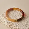 Detail of colorful resin tube bracelet with golden spiral metal accents on stone - Vintage Earth Tone Patchwork (AB0092-4)