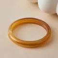 Macro view of bohemian amber acrylic bangle with natural resin marble texture - Honey Amber Style (AB0093-2)