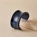 Deep blue acrylic wide open cuff bracelet with light sand texture on stone backdrop - Glossy Deep Blue Style (AB0090-10)