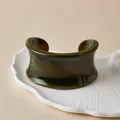 Detail of bohemian acrylic wide cuff bracelet with amber gradient on white tray - Deep Olive Green Gradient Style (AB0090-13)