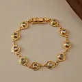 Detailed close-up of 18K gold-plated multi-layer chain bracelet with zircon stones - Radial Textured Round Rhinestone Style (KB0846)