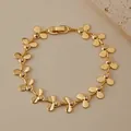 Detailed close-up of 18K gold-plated clover chain bracelet with micro-inlaid crystals - Three Petal Flower Cutout Rhinestone Style (KB0847)