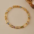 Detail of 18K gold-plated multilayer chain bracelet featuring colorful round zircon stones - Four Prong Multicolor Round Rhinestone Cutout Link Style (KB0848)