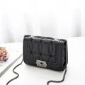 Elegant black chain shoulder bag with circular quilting and vintage metal clasp - Black