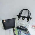 Bolso tipo cubo transparente con margaritas, asa de cuero negro y estuche interior - Negro