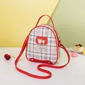 Mini red plaid backpack with pearl cat pendant and matching cross-body strap detail - Red
