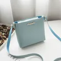Minimalist sky blue crossbody bag with gold logo and matching leather strap - Light Blue