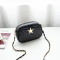 Black PU leather crossbody bag with quilted star pattern and golden tassel accessory - Black